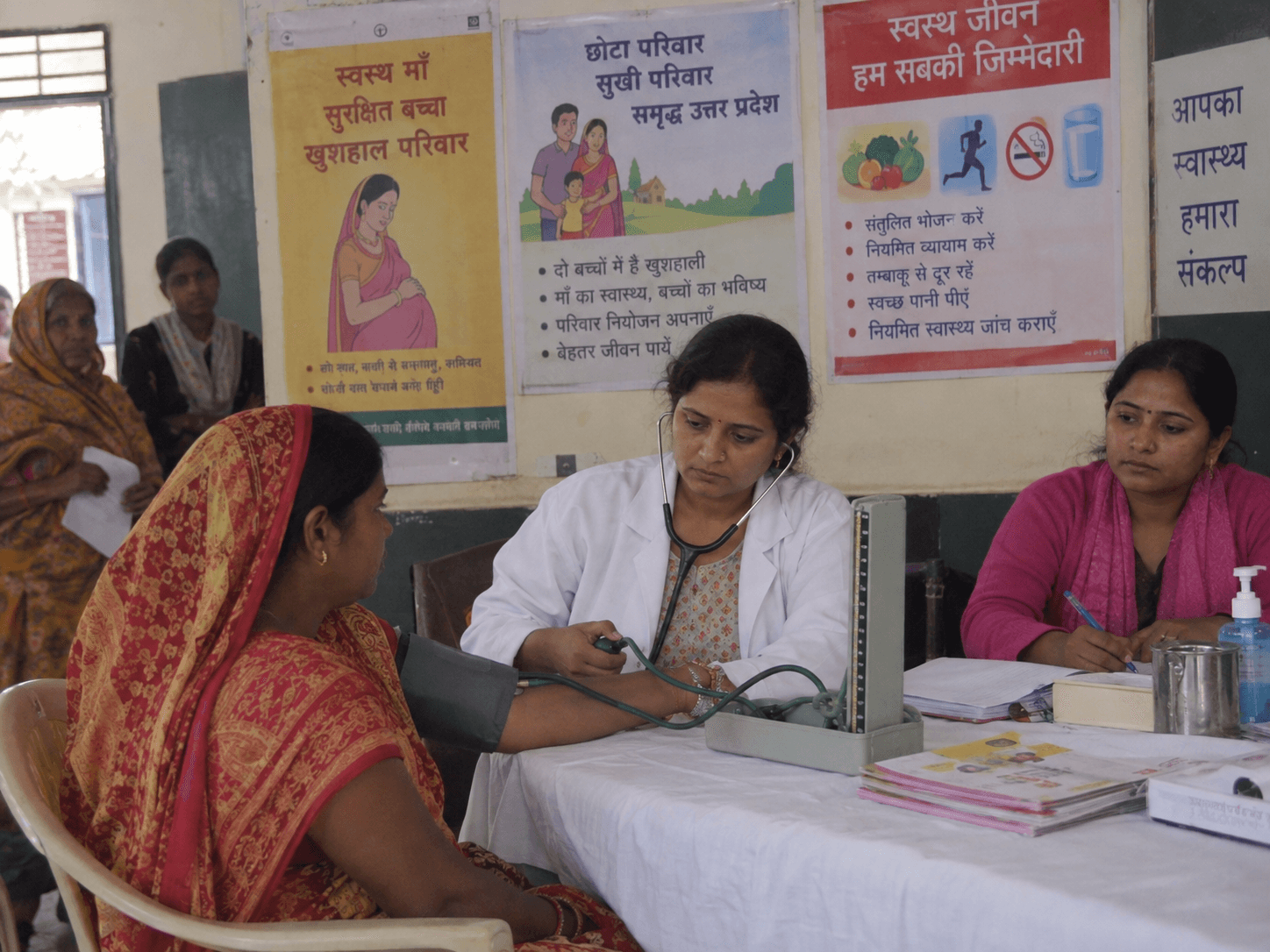 A woman receiving medical consultation during a community health programme