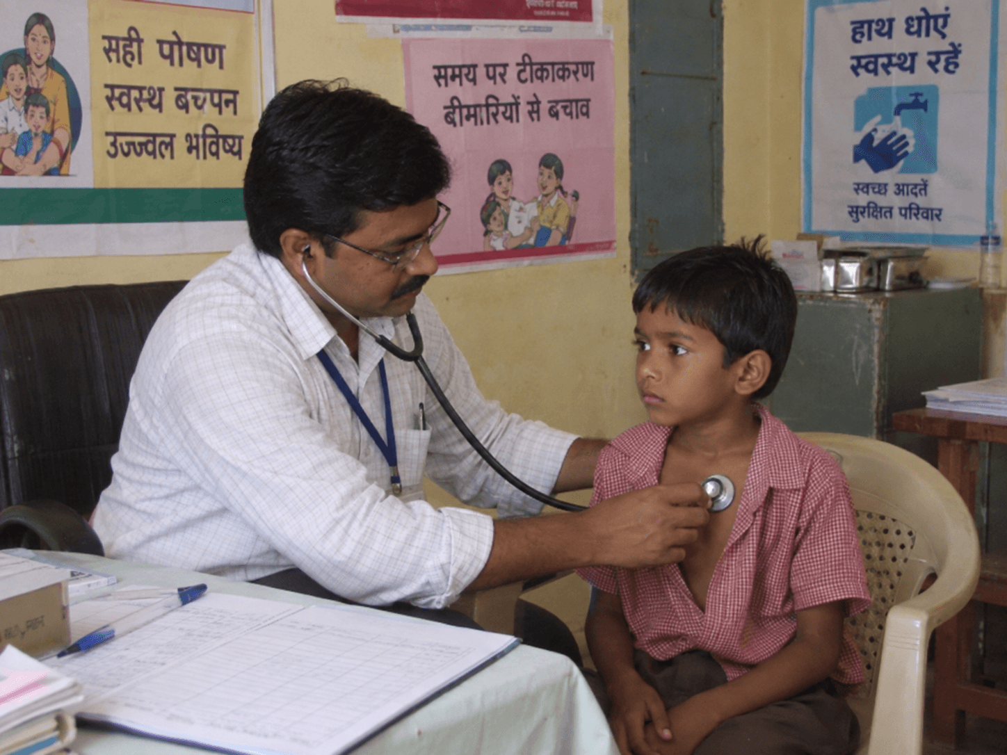 A doctor examining a child during a community health camp