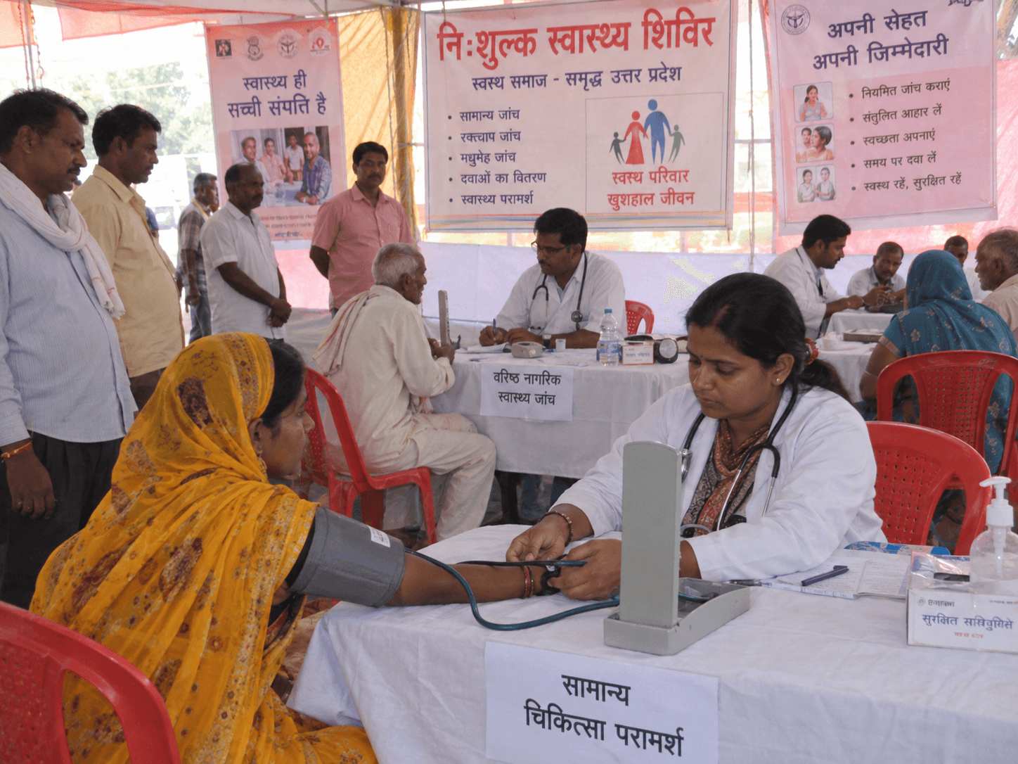 Doctors and patients participating in a free community health camp