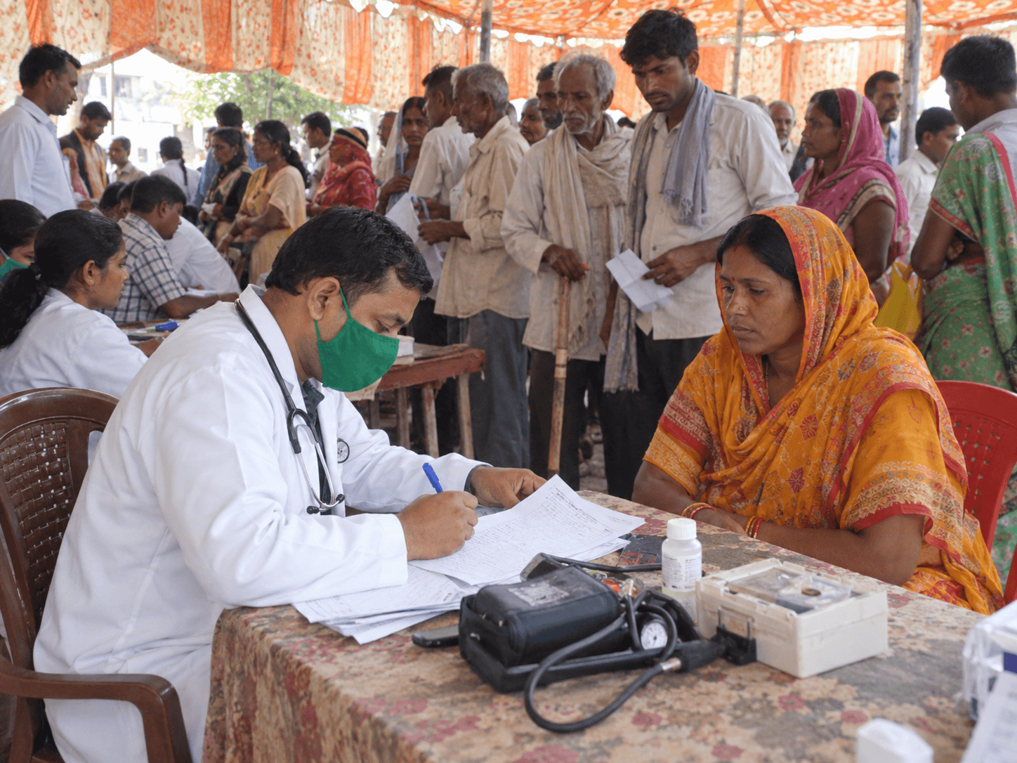 Doctors providing consultation and health screening at a community medical camp