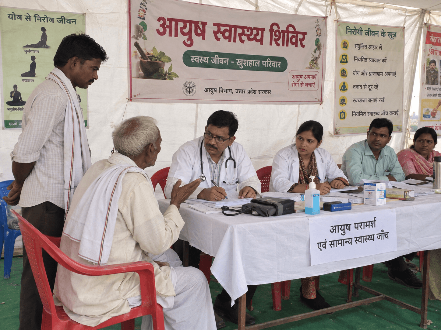 An elderly patient receiving consultation at a community health camp